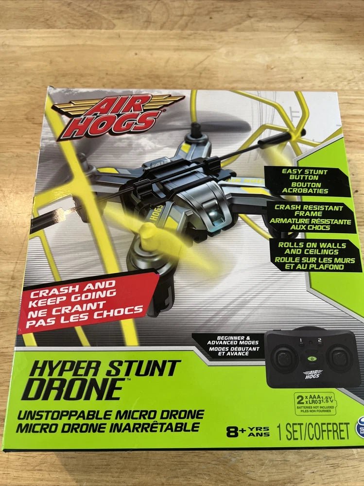 Yellow and black micro RC stunt drone with controller, shown in retail box