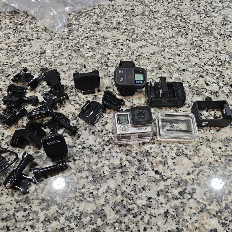 GoPro HERO4 action camera kit with waterproof housing and mounts, multiple black accessories