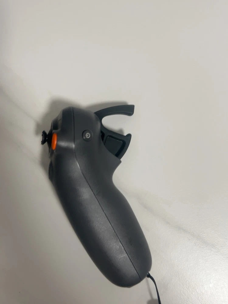 DJI RC Motion 3 motion controller hand grip in dark gray with orange trigger