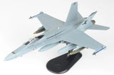 Light blue F/A-18A Hornet 1/72 model aircraft on black display stand, front-left view