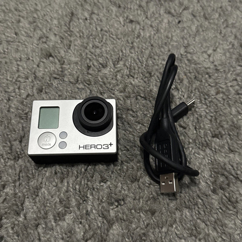 GoPro HERO3+ action camera with black USB charging cable, silver body