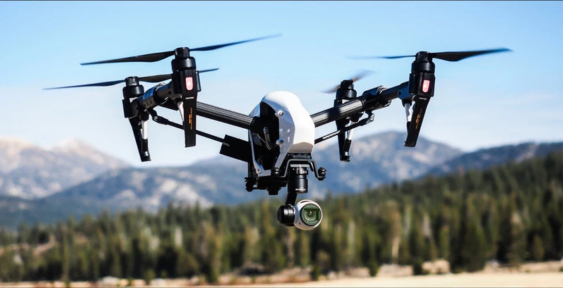 Black quadcopter drone with 4 rotors and front gimbal camera