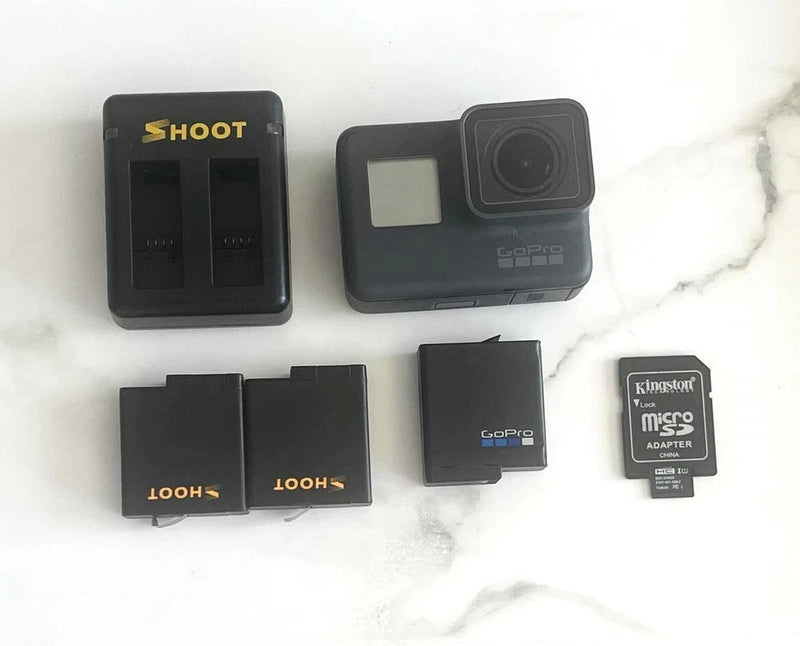 Black action camera kit with dual battery charger, spare batteries, microSD adapter