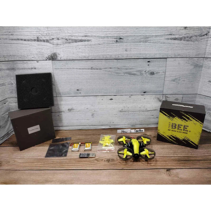 Tiny micro drone with four yellow propellers and included parts