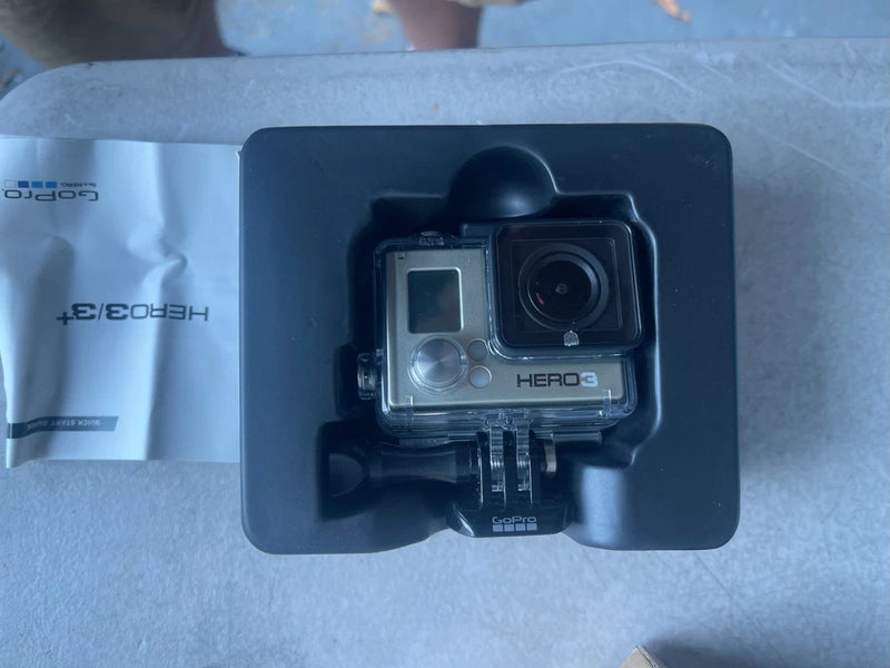 GoPro HERO3 action camera in clear waterproof housing with mounting base