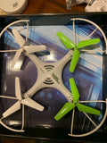 White quadcopter video drone with four green propellers