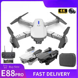 White foldable quadcopter drone with 4 rotors and built-in camera, controller and case.