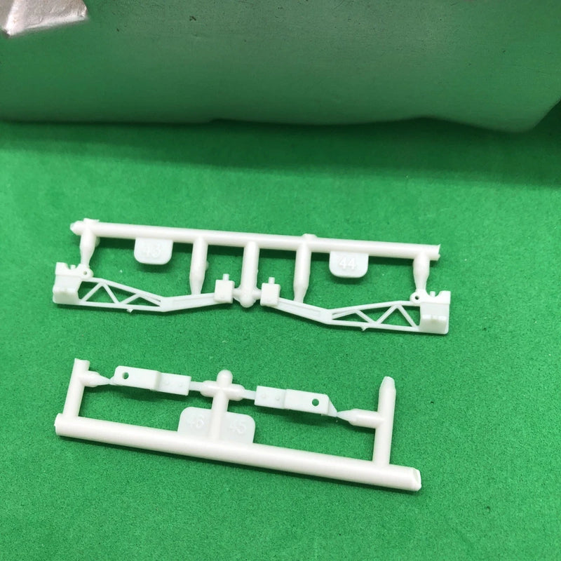 White plastic drag race ladder bar model parts with brackets and cross supports
