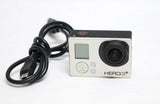 GoPro HERO3+ action camera with front lens, buttons, and connected cable