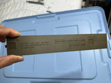 Battery compartment cover door with printed label text, light gray