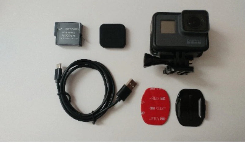 GoPro HERO5 action camera with waterproof case, mount, cables, and lens cover