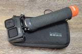 GoPro HERO 9 Black action camera with orange Float Grip, in black case