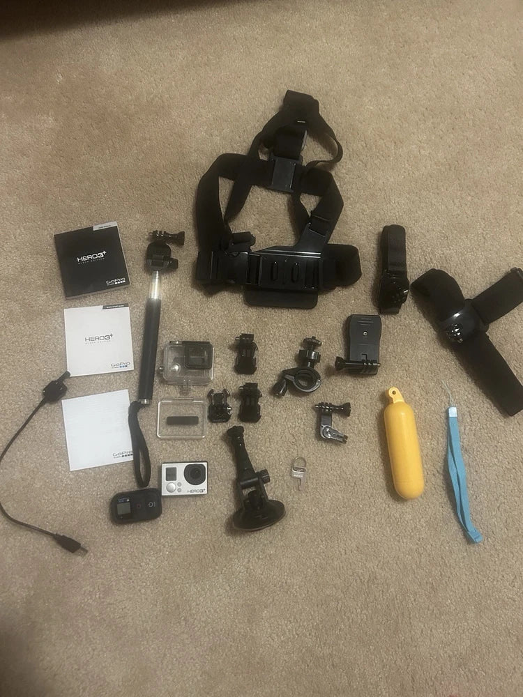 GoPro HERO3+ Black action camera kit with mounts, accessories, and handheld grip