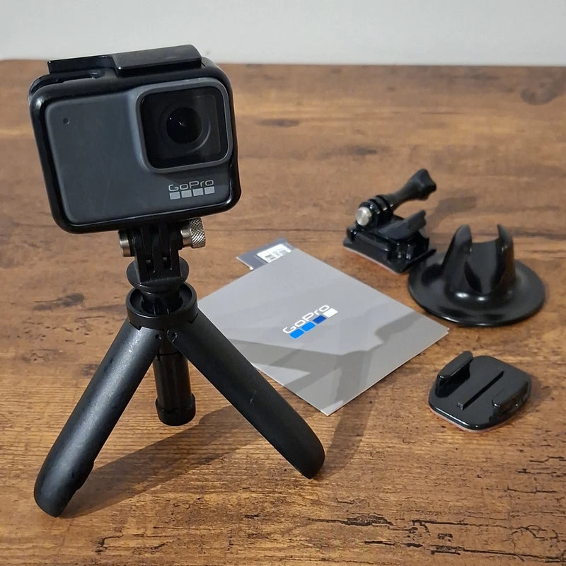 GoPro HERO 7 action camera bundle with tripod mount, extra mounts, and SD card