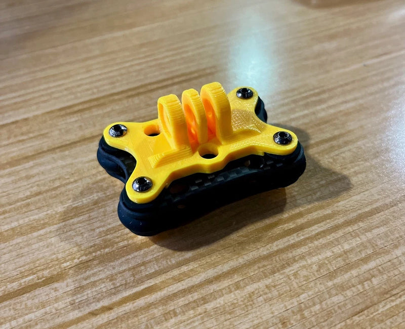 Yellow FPV gimbal mounting bracket with four screw holes and black base