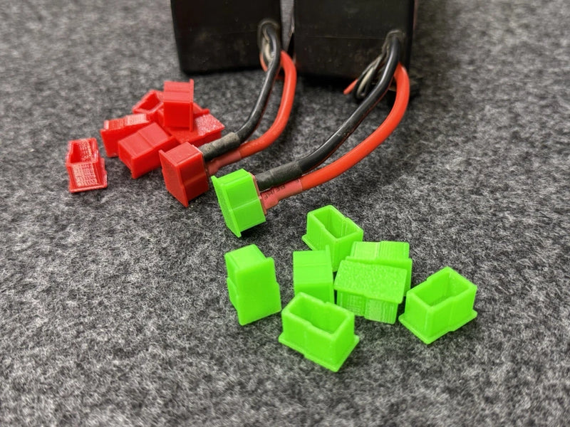 Set of green LiPo battery protection caps with wire connectors and red leads