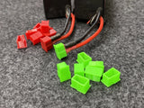 Set of green LiPo battery protection caps with wire connectors and red leads