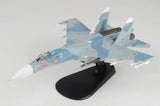 Blue and white fighter jet model on black stand with red markings, 1/72