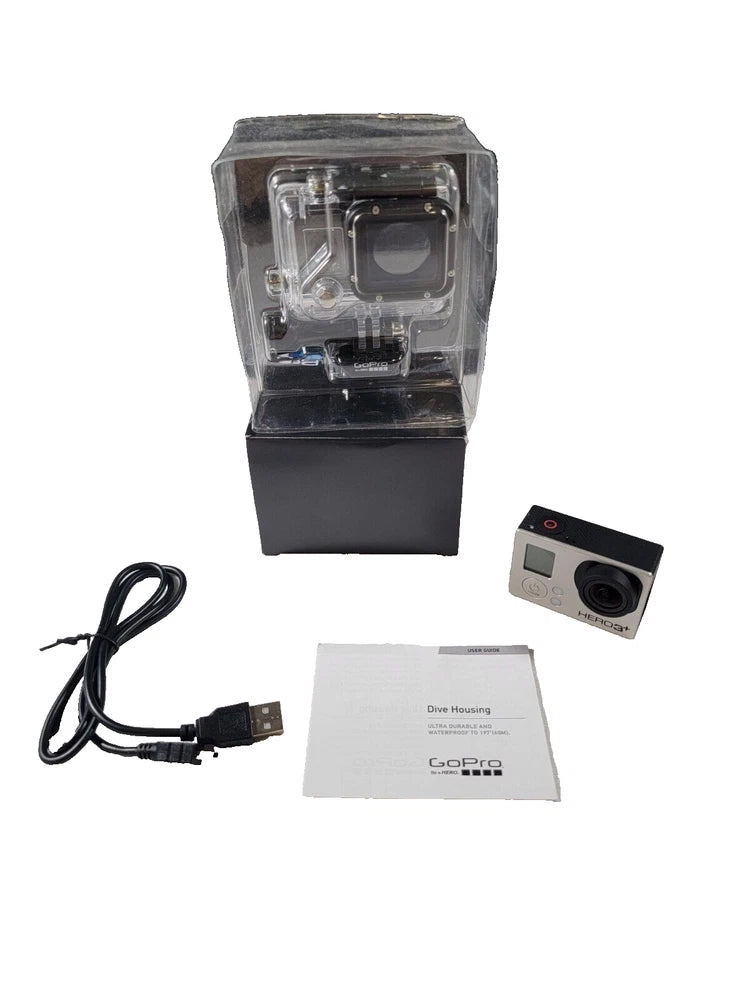 Action camera in clear dive housing with USB cable and instruction card