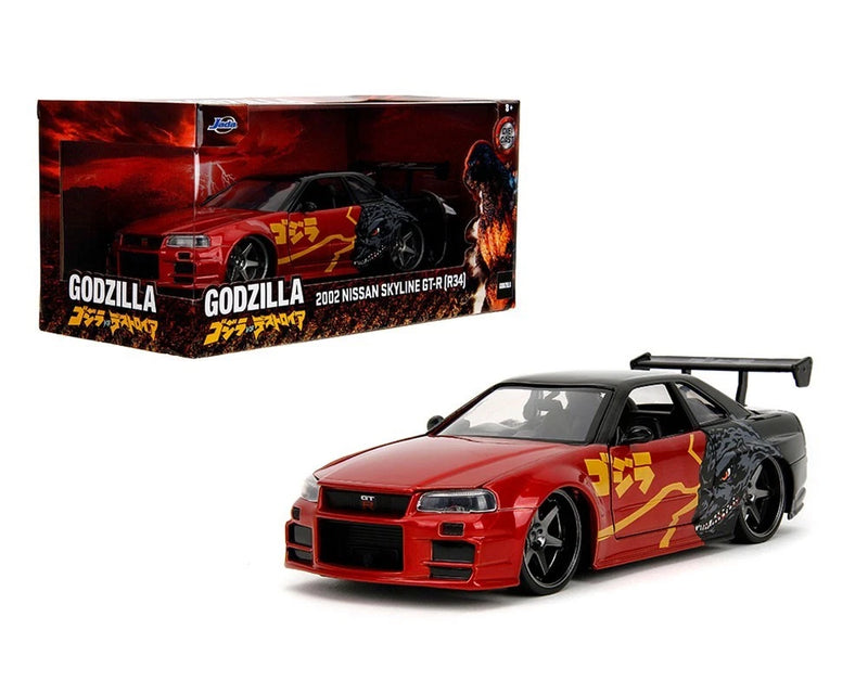 Red and black Nissan Skyline GT-R R34 model car with Godzilla-style yellow graphics, on display.