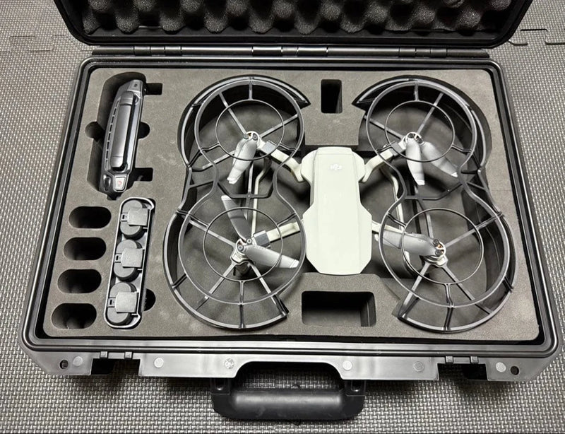 Compact quadcopter drone in hard case with foam cutouts and propeller guards
