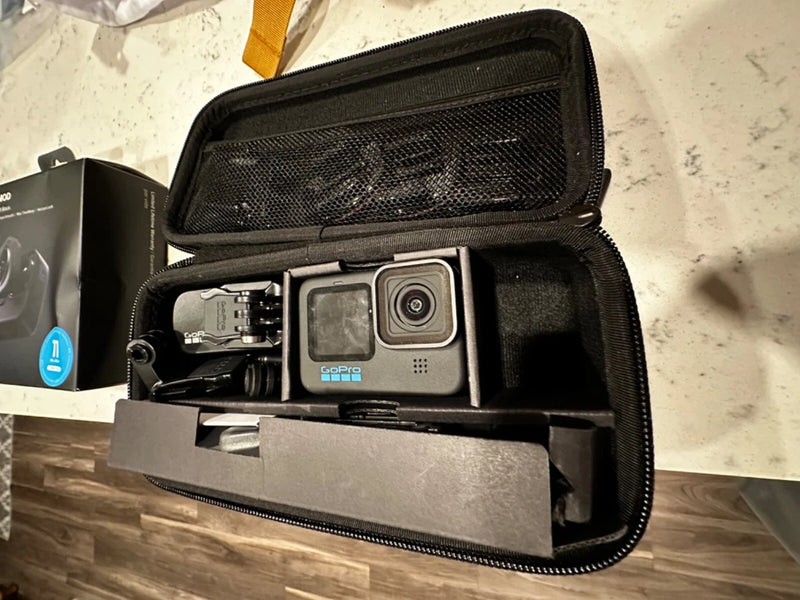 GoPro HERO10 Black action camera in black zip carrying case, front lens visible.