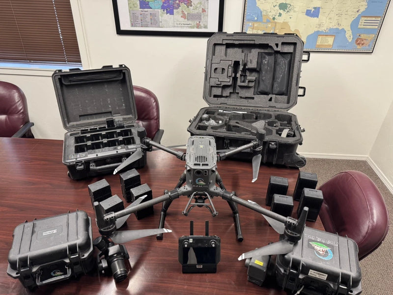 DJI M300 RTK drone with open hard transport case and mounted landing gear
