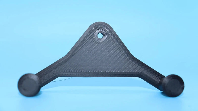 Black drone wall mount bracket with blue center hole and round end pads