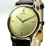 Seiko Dolce quartz wristwatch with cream dial and black leather strap, gold-tone case
