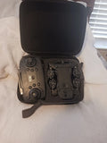 Mini drone and controller inside black hard case with foam insert
