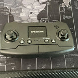 GPS drone remote controller with two joysticks and buttons, dark green/gray
