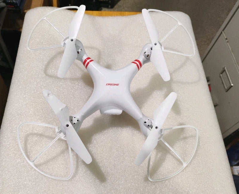 White toy quadcopter drone with four propeller blades and red stripe detail.
