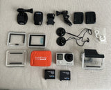 GoPro HERO4 action camera bundle with mounts, housings, and spare frames