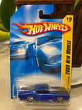 Hot Wheels die-cast car in blue blister pack with flame logo and yellow side panel