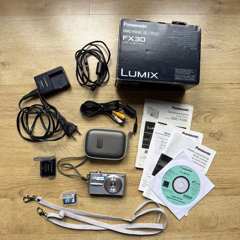 Digital camera accessory kit: Lumix box, carrying case, battery, charger, cables, strap, SD card