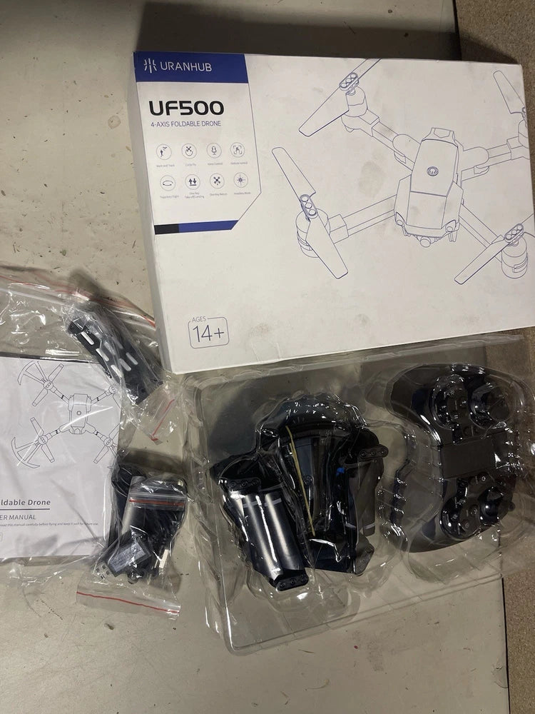 Mini quadcopter drone kit with black propellers and components in blister pack