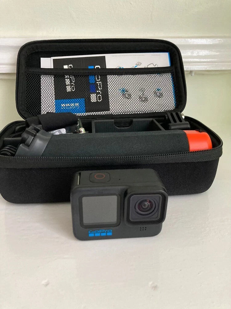 Black action camera with red side accent, inside zippered travel case with foam insert