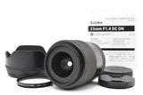 23mm f1.4 DC DN camera lens with front and rear caps and lens hood