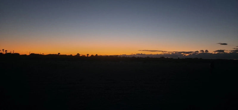 Sunset landscape over a dark horizon