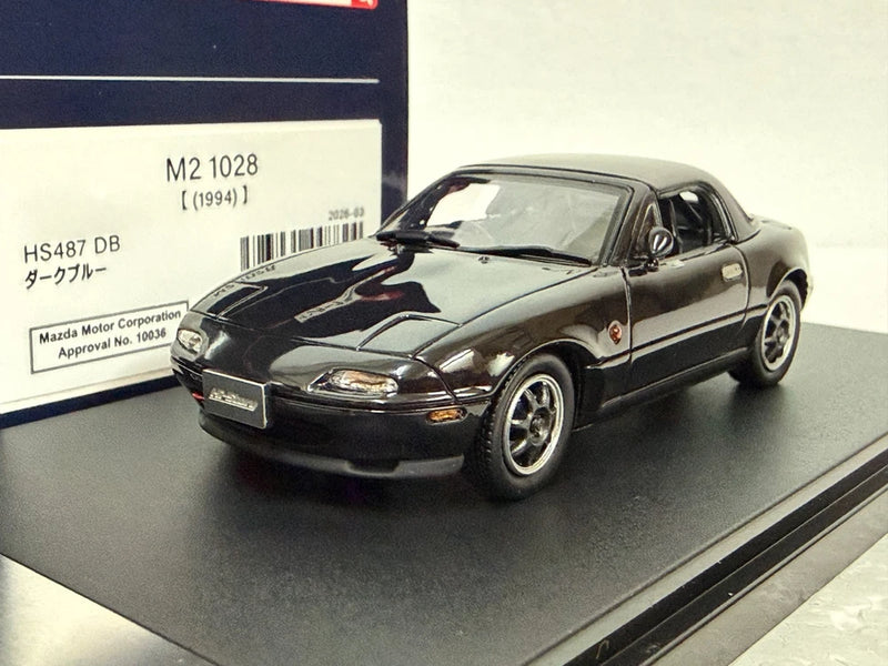 1:43 scale black and silver Mazda roadster racer model car, front 3/4 view