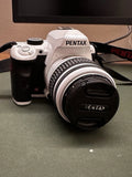 White PENTAX digital SLR camera with 18-55mm lens