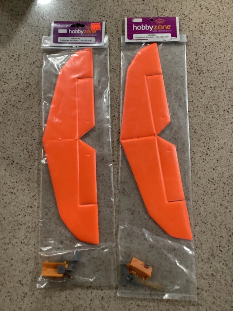 Orange aerobatic tail fins with hinges, in retail packaging