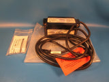 Battery-backed power pack module with attached power cables and warning label