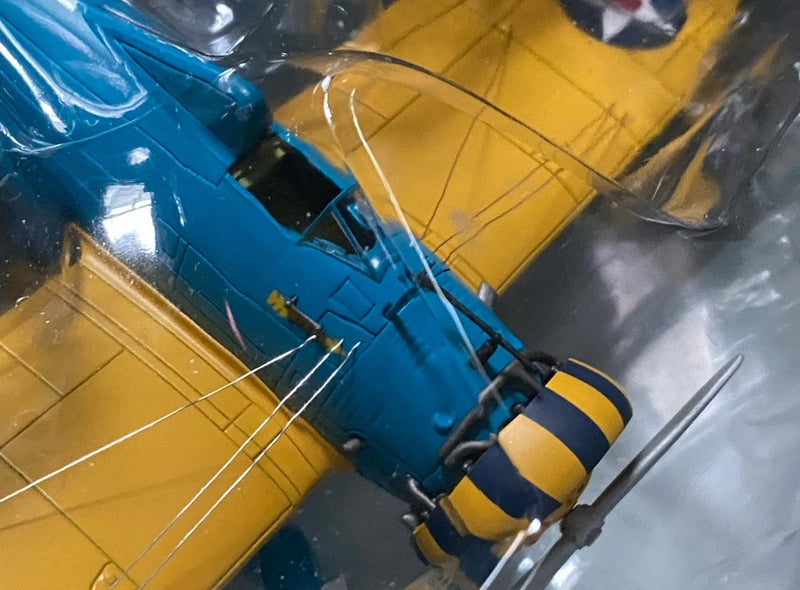 Blue and yellow model airplane with propeller and landing gear