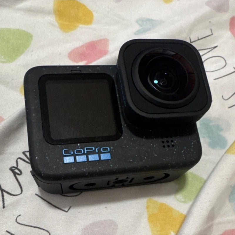 Black GoPro HERO12 action camera with front touchscreen and wide lens housing