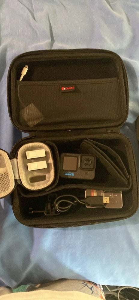 GoPro action camera in black zip case with small accessories and charging cable