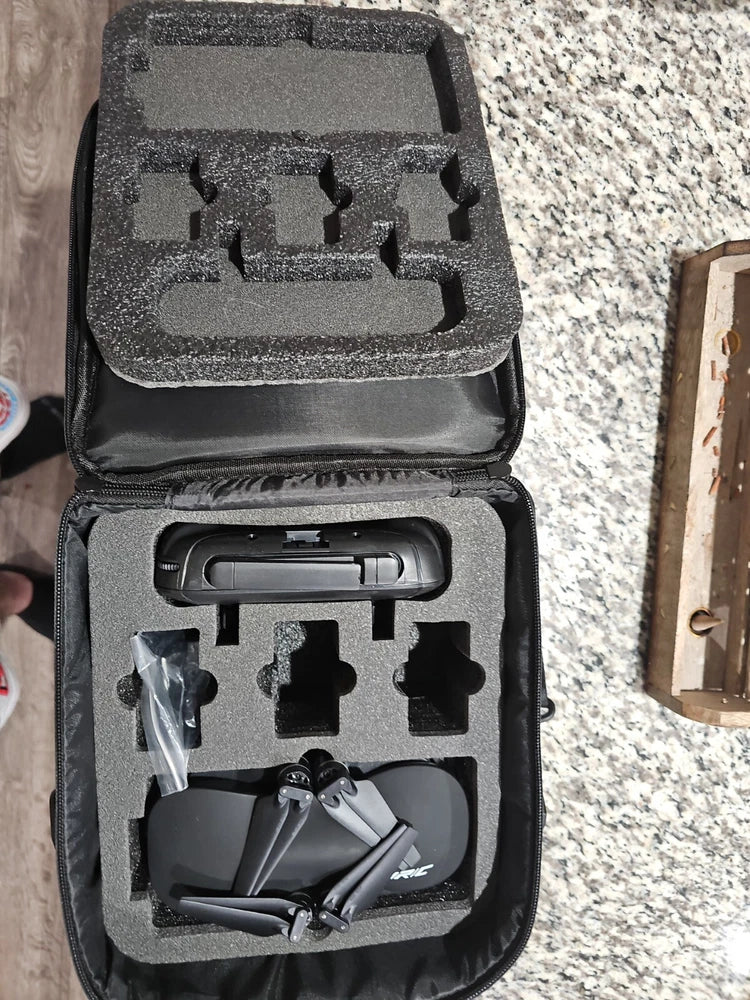 Foldable RC drone in padded travel case, black foam insert with drone components
