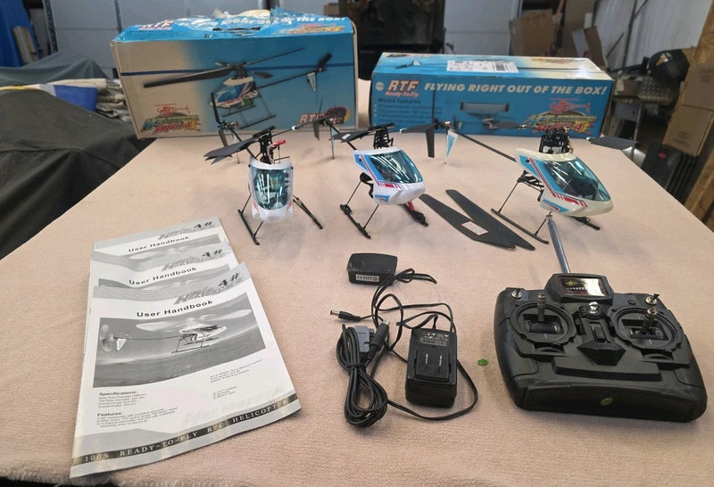 4-channel R/C helicopter bundle with four helicopters, transmitter controller, charger and manuals