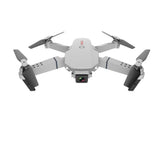 White quadcopter RC drone with front camera and four fold-out propellers