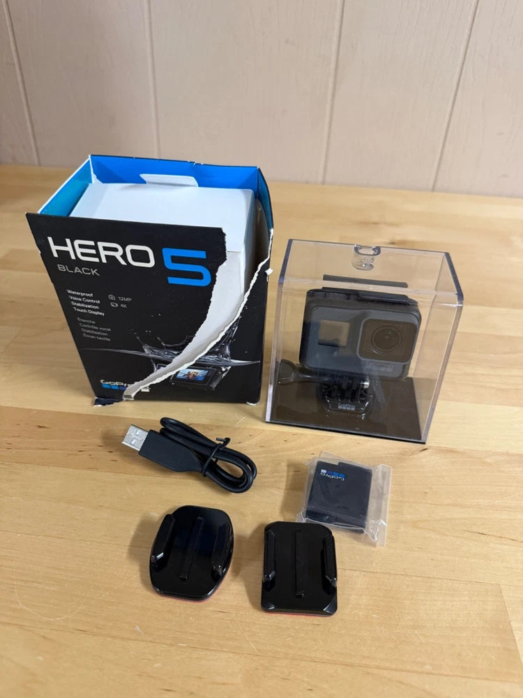 GoPro HERO5 Black action camera bundle with mounts, waterproof case, and charging cable